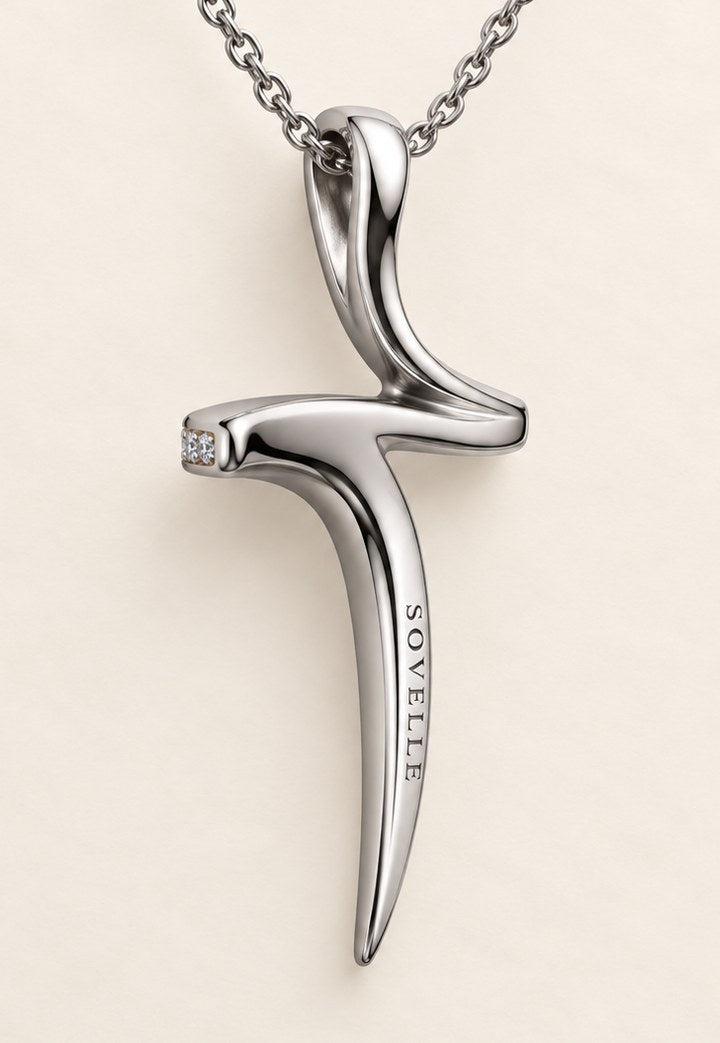The back of the cross pendant in 18ct white gold, the Sovelle wordmark engraved down the stem