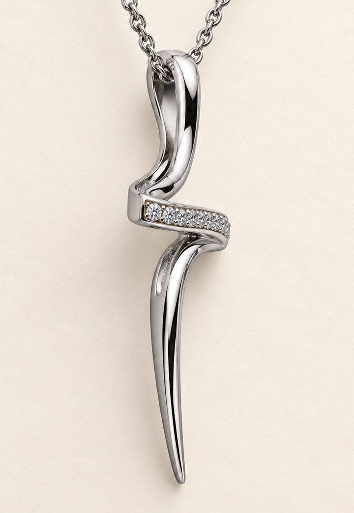 The cross pendant in 18ct white gold seen almost edge on, the crossbar reading as a single line